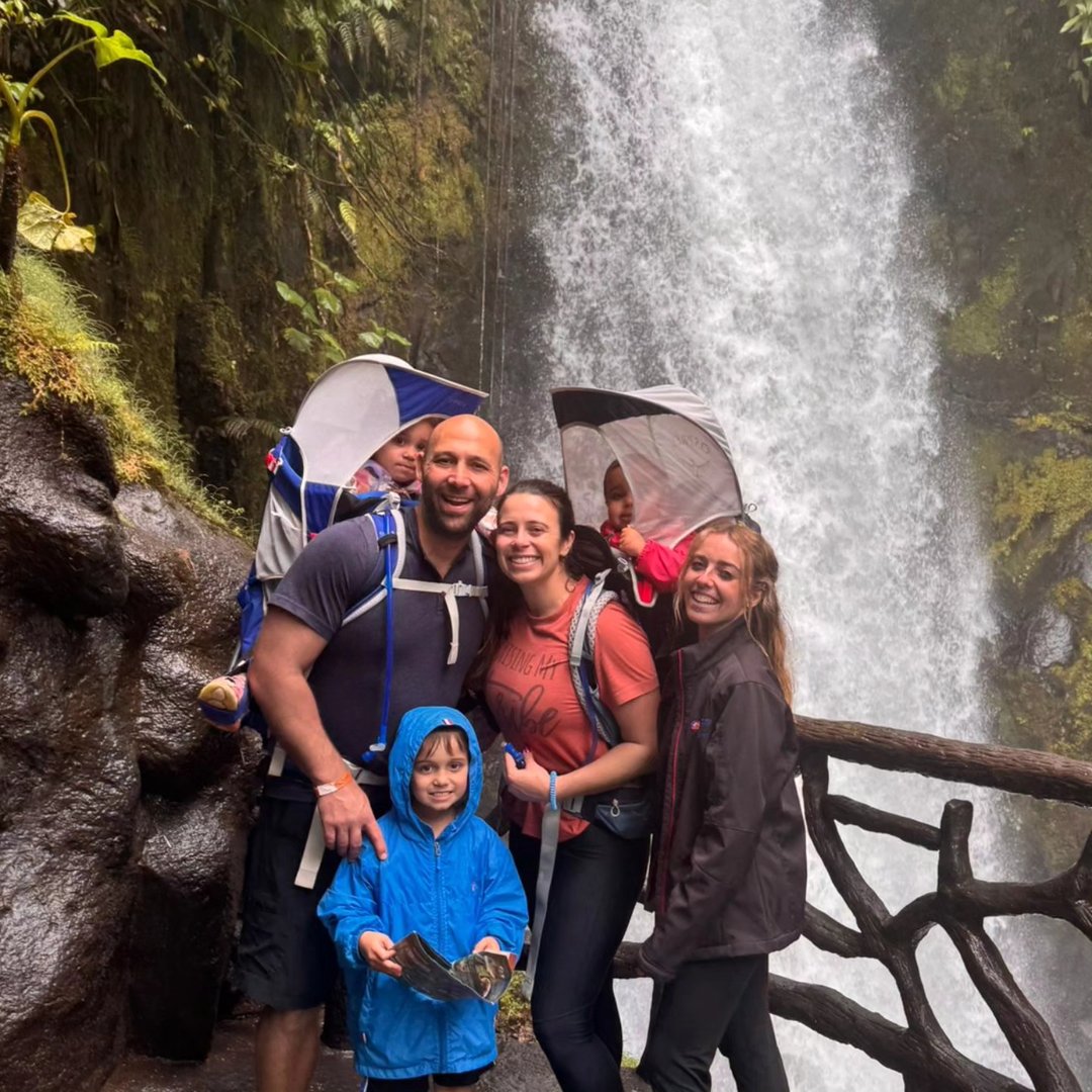 Ashley Thomas with her family in front of a waterfall